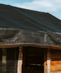 Shade Cloth 70 Percent, 20x20 Ft Heavy Duty Durable Mesh Tarp With Grommets covering a wooden structure, weatherproof for garden use.