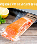 Two Pack Commercial Grade Vacuum Seal Bags And Rolls For Food Storage 8 Inch By 50 Feet And 11 Inch By 50 Feet Microwave And Freezer Safe Sous Vide Ready Keeps Leftovers Fresher Up To Five Times Longer Great For Meal Prep sealing salmon with lemon on wood table