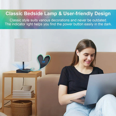 RGBW Touch Lamp with USB Port and AC Outlet on nightstand beside smiling woman using laptop in bedroom setting.