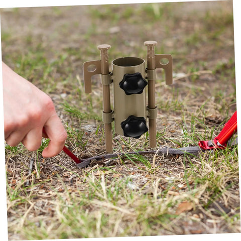 Hand securing Six-Piece Adjustable Camping Tent Pole Kit With Heavy-Duty Aluminum Stakes into grass for stable setup
