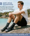 Man on beach wearing Men's Merino Wool Hiking Socks 3 Pack Micro Crew Cushioned Thermoregulating All Season Comfort