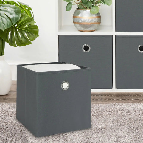 Foldable Gray Storage Cube With Sturdy Metal Ring Handle, No Sweat Shelf Bin Great For Bedroom Or Living Room, Quick Wipe Clean Fabric Organizer To Snap Shut And Hold Your Daily Gear on a carpet, featuring a gray design.