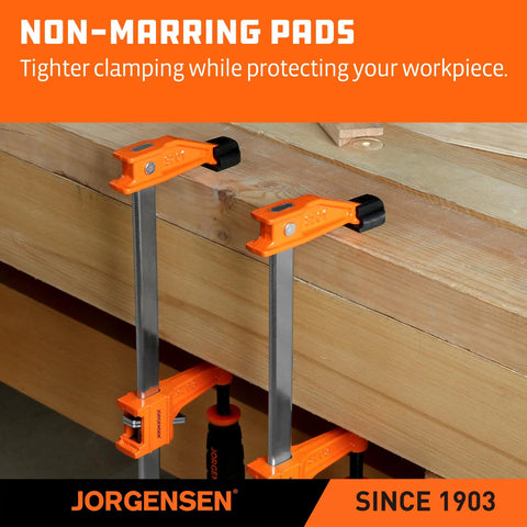 Two orange Jorgensen 24-inch steel bar clamps securing a wood plank