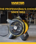 Heavy Duty Utility Blower With 3 Speed Portable Floor Fan, pivoting head, built-in outlet, rugged construction in workshop setting