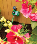 Electronic Digital Hose End Timer For Garden Irrigation, Battery Operated, attached to hose with flowers in foreground