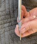 Close-up of Lincoln 5803 hand-held grease gun needle nozzle with hardened steel tip and 1/8 in NPT thread