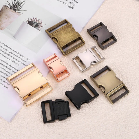 Assorted metal quick side release buckles in various finishes, including zinc alloy, for backpack straps and dog collars.