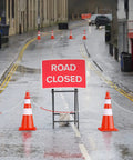Road closed sign with orange traffic cones linked by 32 Foot Plastic Chain With 6 Connector Kits For Linking Traffic Cones And Barriers A Pro Grade Setup For Construction Sites Roadwork Parking Lots Driveways And Home Use.