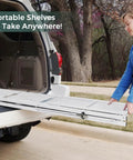 Five Shelf Folding Bookshelf With Wheels For Easy Go Anywhere Setup No Fuss Heavy Duty Freestanding Metal Wire Storage Rack For Living Room Office Kitchen Basement Pantry In White folded into SUV cargo area