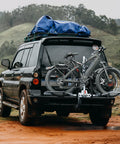 Dope 2-Bike Hitch Rack For Car With Quick Release Handle on SUV carrying two bikes, showing wobble-free design and tilting feature.