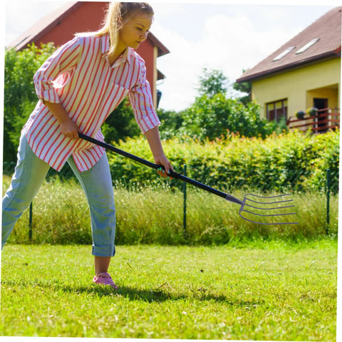 Woman using Heavy Duty Iron Manure Fork For Household Use And Lawn Cleanup Multi Functional Grass Fork For Quick Yard Work