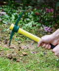 Using Drop Forged 15 Inch One Piece Adze Pick Garden Tool For Weeding And Digging, 1.4Lb Pick Axe in a garden setting.