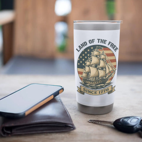 Patriotic Stainless Steel Insulated Tumbler With US Flag Sailboat Design, Keeps Drinks Cold Or Hot, Great 4th Of July Gift on table
