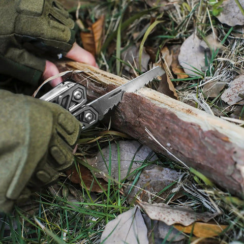 Multitool 21 In 1 Stainless Steel Pocket Knife With Screwdriver Sleeve Self Locking Pliers being used to saw a log outdoors.