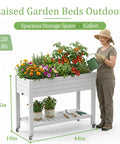 Raised Garden Bed On Wheels With Storage Shelf And Water Level Monitor, Elevated Planter filled with herbs and vegetables, grayish white