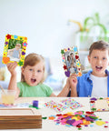 Children holding decorated frames from 24 Pack Picture Frame Craft Kit For 4x6 Photos Unfinished Wooden Frames With Diamond And Foam Stickers DIY Paint And Decor Supplies Includes 150 Rainbow Glitter Foam Stickers In Heart And Star Shapes And 2 Sheets Rhinestones in a creative setting.