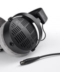 Close-up of DT 900 PRO X Studio Open Back Headphones with detachable cable, showing space grey finish and over-ear design for precise mixing.