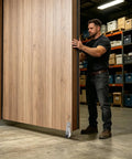 Man operating a sliding door with Heavy Duty Vertical Track Roller Wheel Engineered For Driveway Gates With Whisper Quiet Ball Bearings And Four Screw Bracket Kit For Slick As Butter Rolling Without Any Hustle.