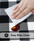 Hand wiping sauce off Round Picnic Tablecloth With Elastic Edges Waterproof Fitted Vinyl Cover For 36 to 44 Inch Tables Flannel Back Buffalo Plaid Black And White No Slip Windproof Outdoor Dining.