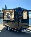 Heavy Duty Turnkey Commercial Grade Black Taco Food Truck And Slick Mobile Catering Trailer With Private Restroom and DOT Certified Build For Operations at waterfront.