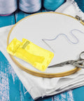 Twelve Piece Automatic Needle Threaders For Hand Sewing And Embroidery With Portable Design And Universal Fit Yellow Threading Tool on hoop fabric