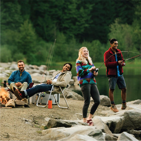 Group of four people fishing by a lake with rods and outdoor gear, featuring Salt Fisher 33 Spincast Reel And Rod Combo, medium-heavy rod