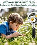 Child exploring flowers with a magnifying glass in a field, emphasizing nature exploration and engagement.