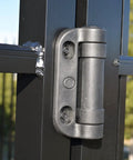 Heavy Duty Gate Hinge With Built Tough Construction And No Sweat Install For Pool Fences Or Commercial Gates Delivering Reliable Tension Adjustment Holding 1128 Pound Loads on black fence.