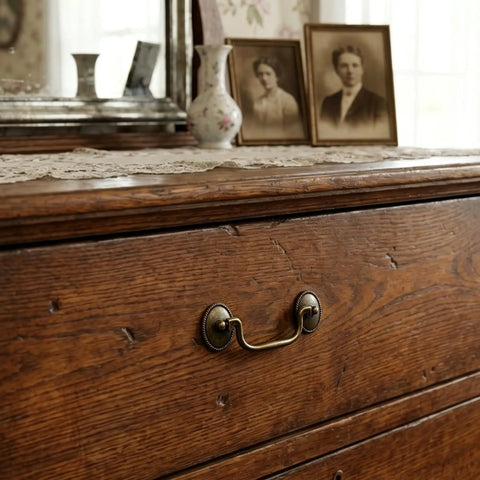 Six Pack Vintage Bail Drawer Pulls In Antique Brass, 3-3/8 Inch Hole Centers on wooden dresser, close-up of handle