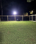 Ultra Bright Solar Motion Flood Light Outdoor Waterproof illuminating fenced yard, showcasing 360-degree illumination