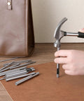 Person using Pro Grade Beefy Leather Hole Punch Set with 0.5 to 7mm hollow punches on leather surface