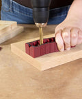 Person using Drill Block Plus Handheld Drilling Guide For DIYers And Home Crafters Nine Imperial Drill Bit Sizes on wooden surface