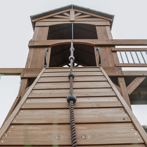 View of Cedar Wood Swing Set With Wave Slide And Raised Clubhouse Plus Balcony, wooden bridge, rock wall, rope ladder