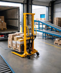 Tough Manual Straddle Pallet Stacker Powers Through 2200 Lbs Loads Without Breaking A Sweat Features Hand Hydraulic Pump And 63 Inch Lift Height For Quick Warehouse Workflows Daily in warehouse, lifting loaded pallet.