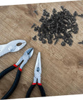 Straight Up Kickass 100 Pack Miniature Metal Furniture Screws With Ultra Deep Threads for home projects and pliers on wooden surface.