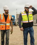 Two men wearing Mens High Visibility Reflective Safety Vest Premium Black Bottom Zipper Ansi Class 2 Construction Utility Workwear Lime Green Large on a worksite.