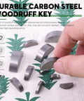 Woodruff key assortment set, 150 pcs, 15 metric sizes, carbon steel; close-up of semicircular keys held by fingers