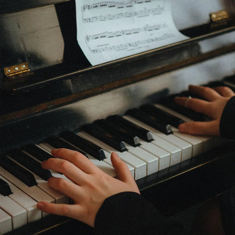 Hands playing a piano with sheet music, showcasing the Copper Piano Hinges Set for Jewelry Boxes and Cabinets Four Smooth Quiet Folding Butt Hinges Easy to Install and Replace Handy for Tool Boxes Small Furniture Diy Projects and Crafts use in delicate items.