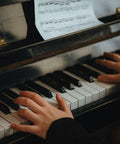 Person playing piano with visible piano hinges, related to Four Piece Copper Piano Hinges For Small Wooden Boxes Crafts Not Easy To Rust Built To Last