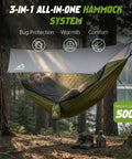 Man relaxing in 2 Person Camping Hammock With Mosquito Net And Built In Underquilt, Rain Fly Tarp in forest setting