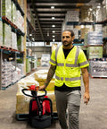 Powerhouse Full Electric Pallet Jack Bundle With Amps Boosting 4800 Lbs Capacity And 48 Inch Forks Plus Huge 48 Volt Lithium Battery in use by worker.
