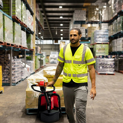 Powerful 48-Volt Electric Pallet Jack For Smooth Moves Heavy Duty Forklift with operator in warehouse handling pallets.