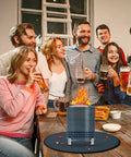 Group enjoying indoor gathering with 20 Inch Fire Pit Mat For Tabletop Grills And Stoves Triple Layer Fireproof Heat Resistant Pad