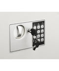 Front view of hidden in-wall safe with keypad and two manual override keys installed, ideal for home or office security.