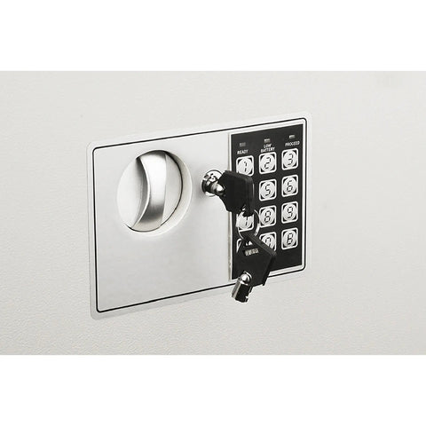 Front view of hidden in-wall safe with keypad and two manual override keys installed, ideal for home or office security.