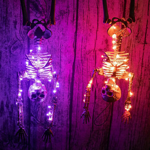 Two skeletons decorated with RGB Fairy String Lights 33ft With 66 LEDs App Control 44 Modes Color Changing Music Sync Waterproof.