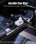 Slick 200W Car Power Inverter With Four Usb Ports And Dual Ac Outlets Transforming 12V Dc Into 110V Ac No Sweat Setup For Laptops Cpaps Game Consoles And Tailgate Parties White in car with smartphone and laptop charging.