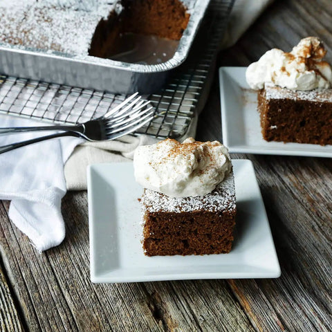 Brownie slices on plates next to 35 Pack 8x8 Inch Square Baking Pans With Snap-On Plastic Dome Lids, Heavy Duty Disposable Aluminum Foil Tins.