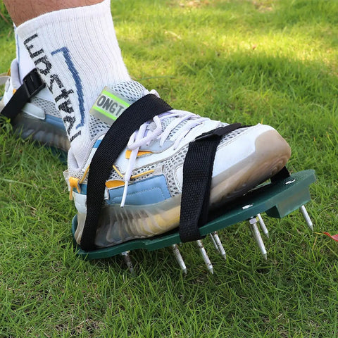 Person using Adjustable Lawn Aerator Shoes Straps With 8 Pieces Garden Spike Laces for Soil Aeration on grass.