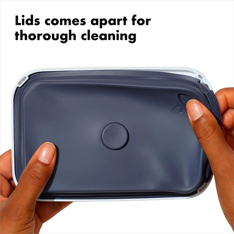 Person holding lid of 0.4L Airtight Herb Storage Container For Spices And Pantry Staples, Stackable No Fuss Space Saving Design Keeps Dried Herbs Fresh, Clear Lid For Easy Visibility, showing detachable design for easy cleaning.